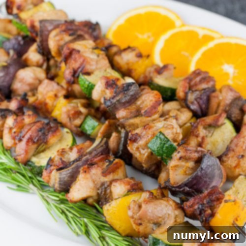Orange Rosemary Chicken Kebabs on a white platter.