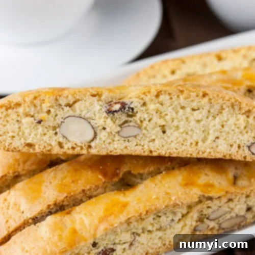 Almond Biscotti stacked on a white plate.