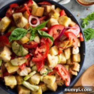 Close up of Panzanella salad garnished with fresh basil.