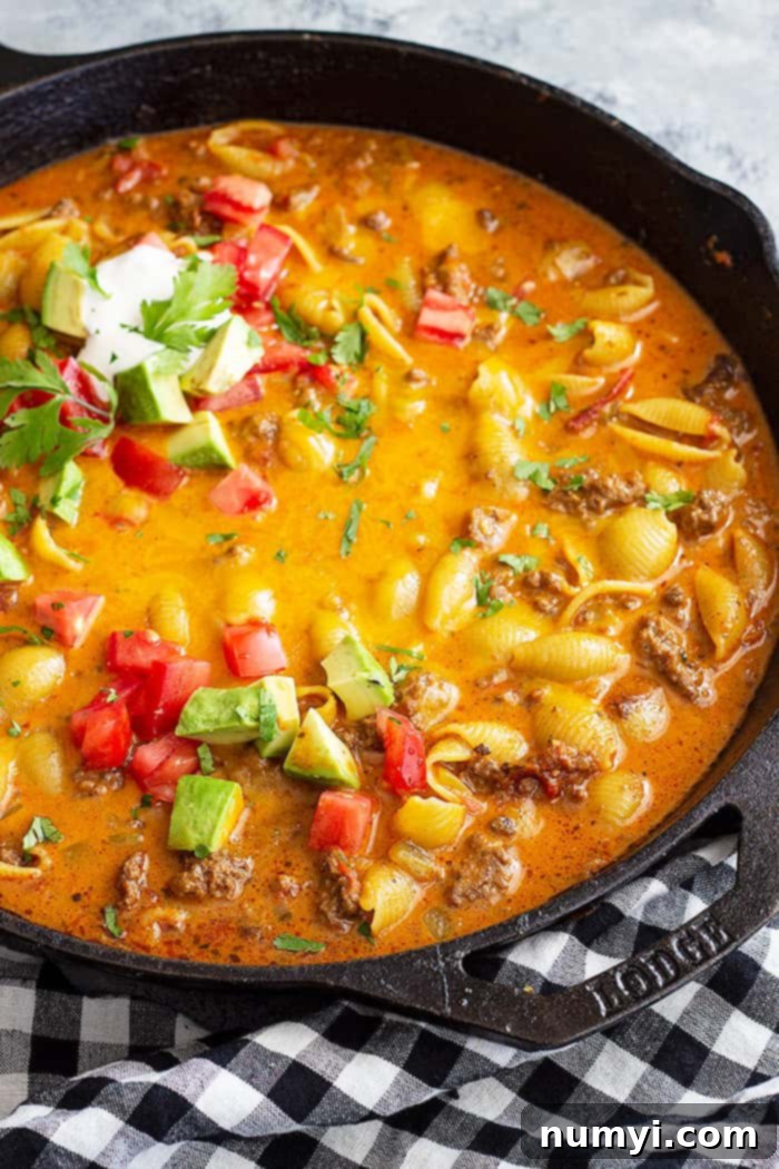 Creamy Cheesy Taco Pasta 5 Large pan of taco pasta topped with taco toppings.
