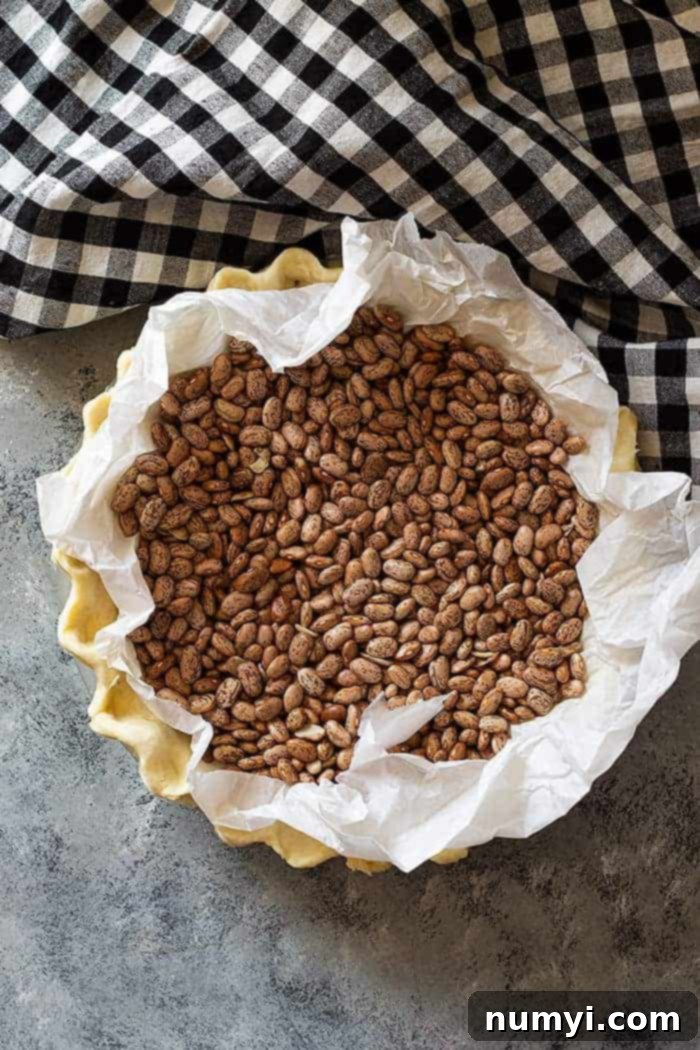 overhead: pie crust filled with blind baking beans 