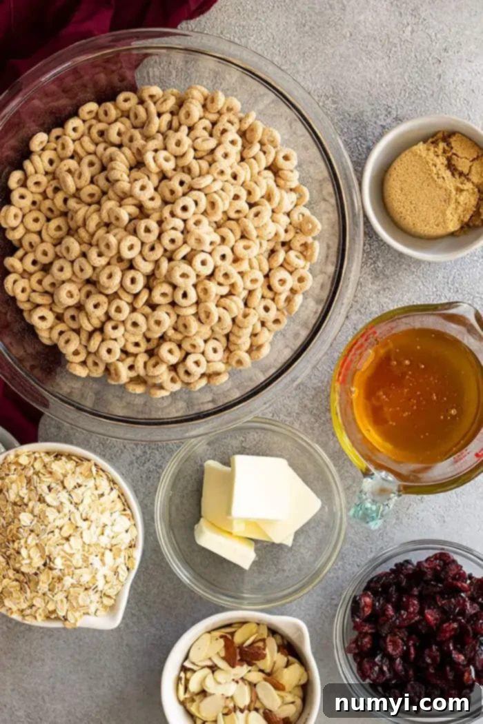 Overhead view of all the ingredients laid out on a wooden surface, ready to be mixed for the granola bars.