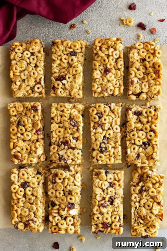 Overhead view of homemade Cheerio granola bars, freshly cut into uniform rectangles.