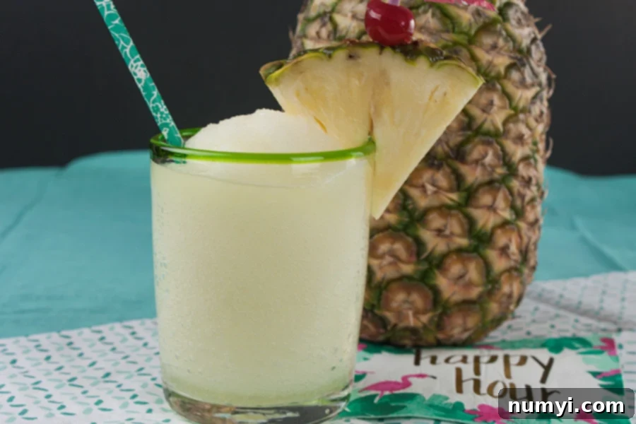 Vibrant Jamaican Me Crazy cocktail, garnished with a fresh pineapple wedge, served in an elegant short glass.
