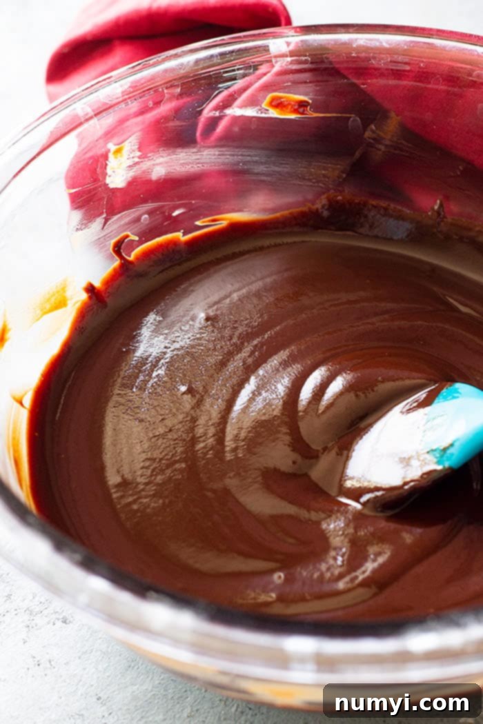 Smooth, glossy chocolate ganache in a mixing bowl, ready to be chilled.
