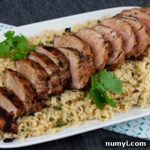Grilled Adobo Pork Tenderloin - Sliced pork tenderloin on a bed of cilantro lime rice.