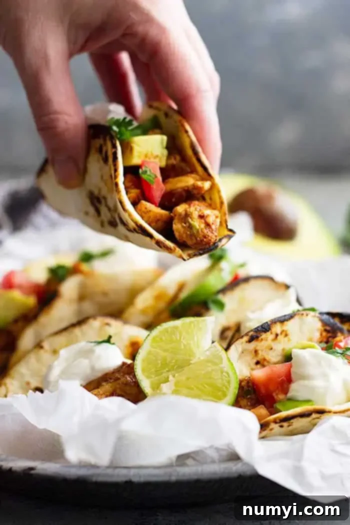 Blazing Chicken Tacos 4 hand holding a spicy chicken taco