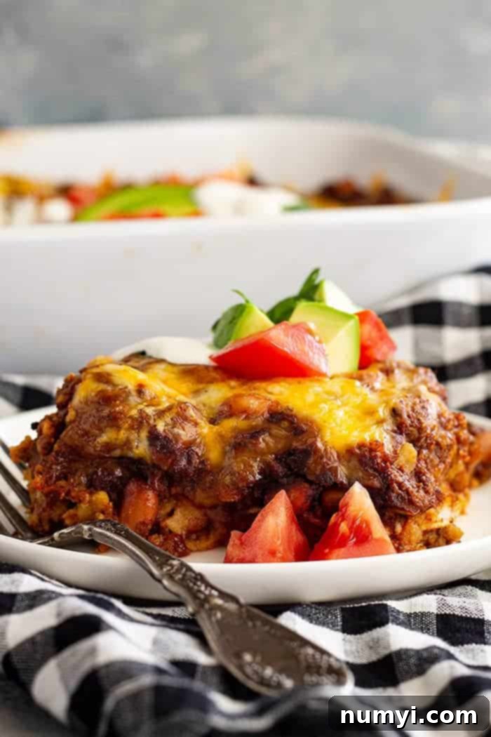 plate of Mexican casserole on a black and white checkered towel