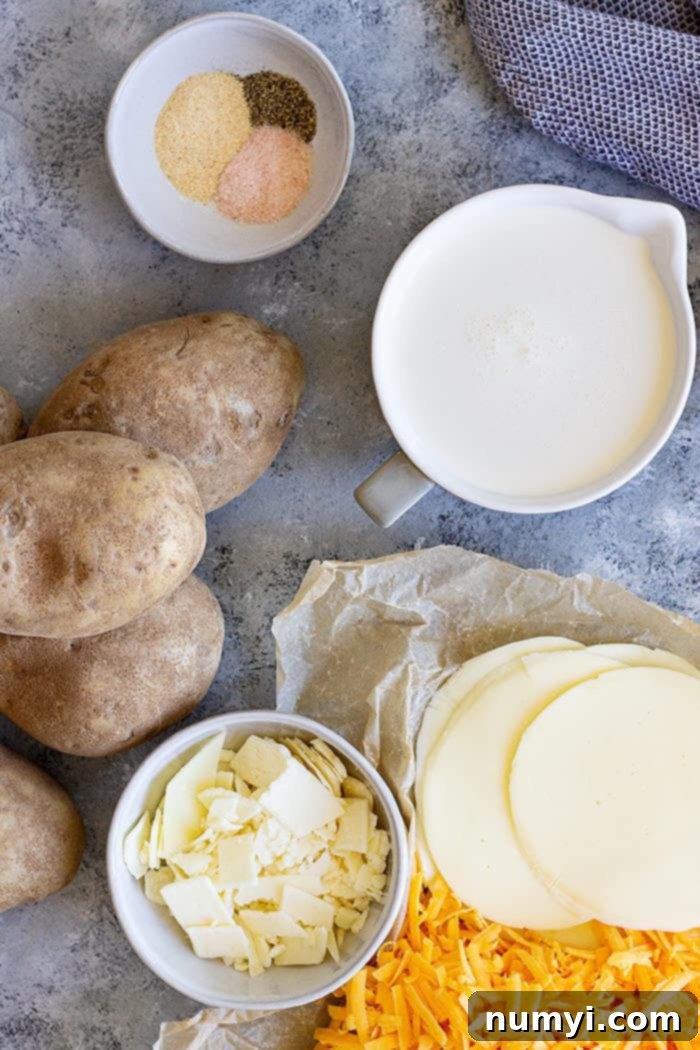 Top-down view of the ingredients for potatoes au gratin, including sliced potatoes, cheese, and cream.