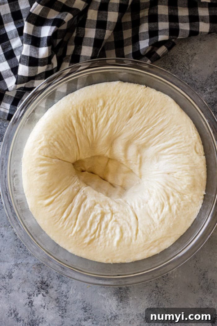 Punching the dough down after the first rise.