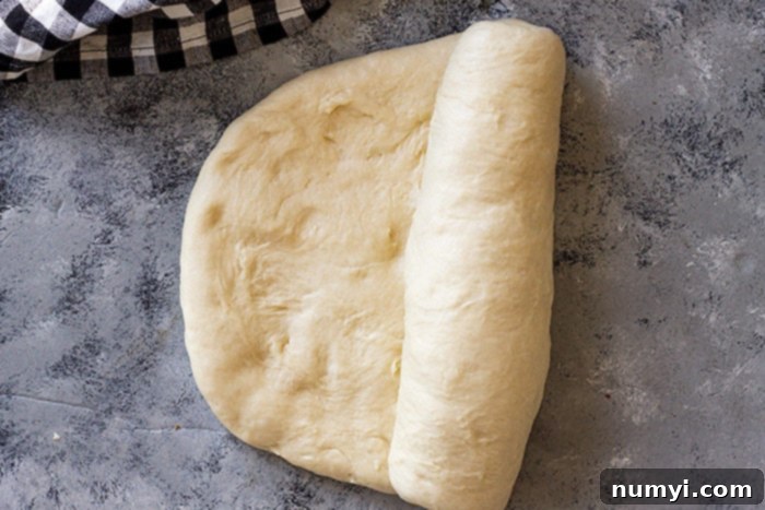 Shaping the dough to be placed in the bread pan.