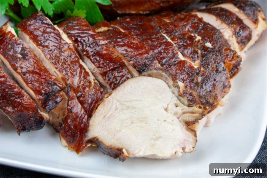  sliced smoked turkey breast on a white platter