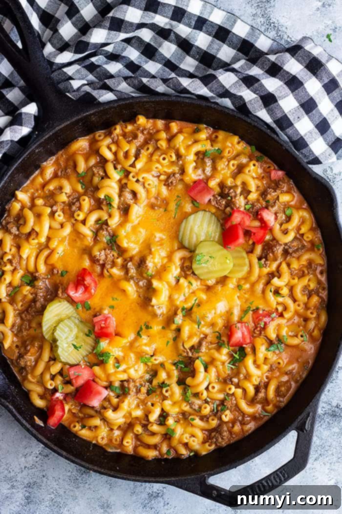 A top down view of cheeseburger pasta in a cast iron skillet.