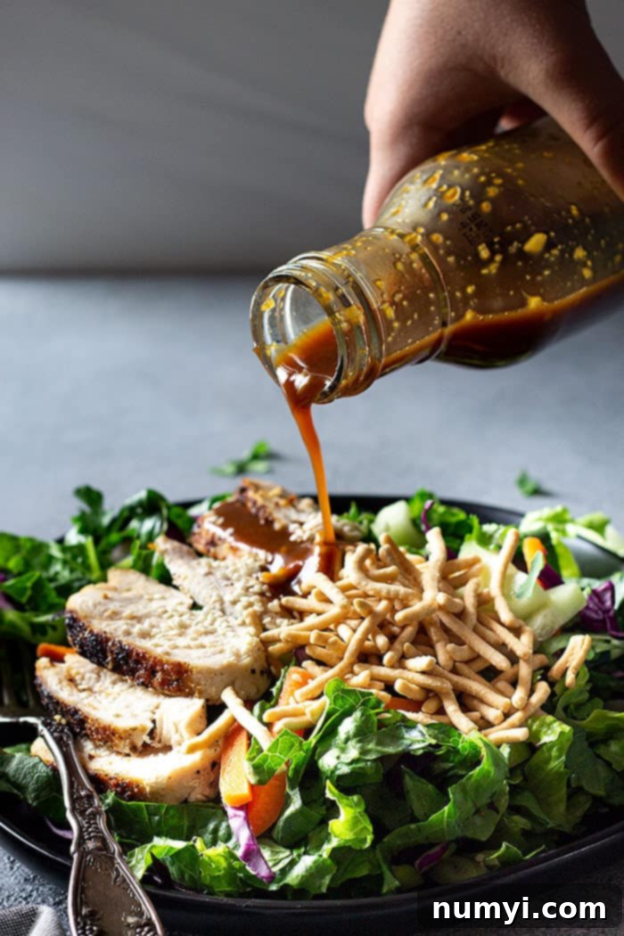 pouring dressing over a salad.