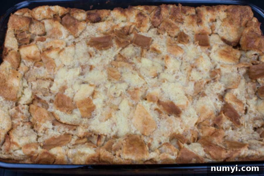 The bread pudding mixture after soaking overnight in the refrigerator, showing fully saturated bread cubes.