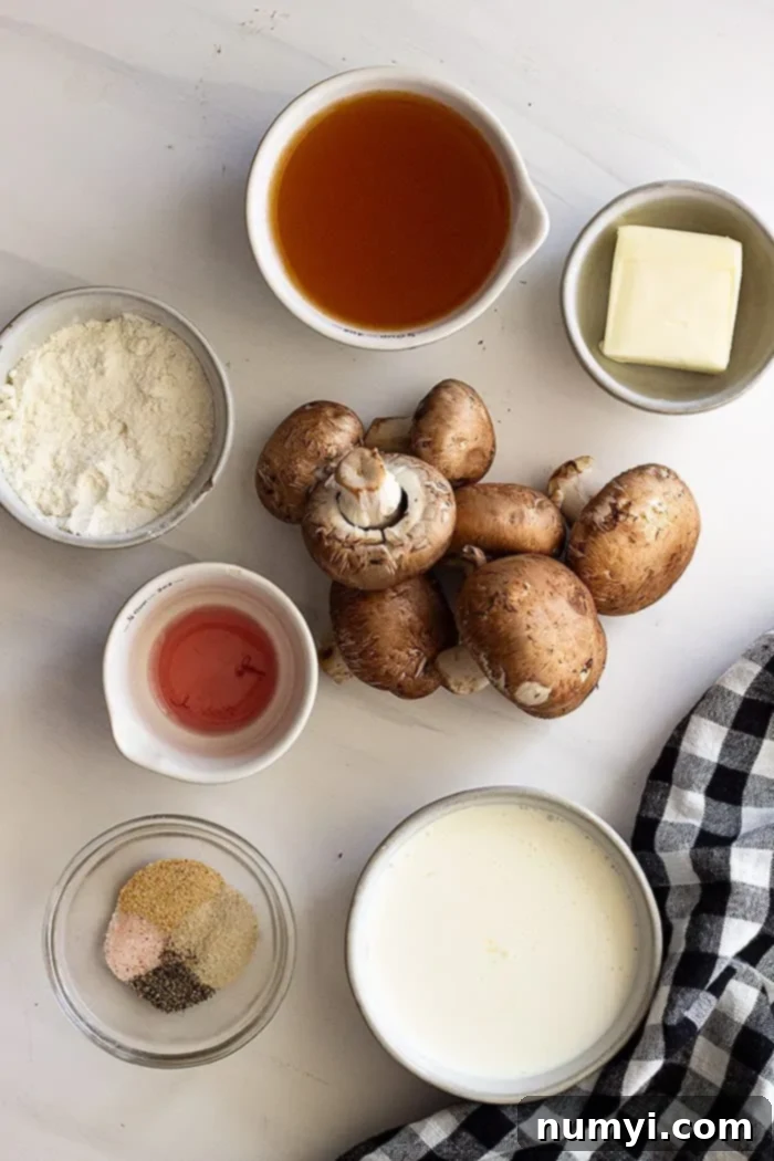From Scratch Creamy Mushroom Concentrate 3 An overhead shot showcasing all the fresh, high-quality ingredients needed for homemade condensed cream of mushroom soup, including mushrooms, butter, flour, broth, cream, and seasonings, neatly arranged on a rustic wooden board.
