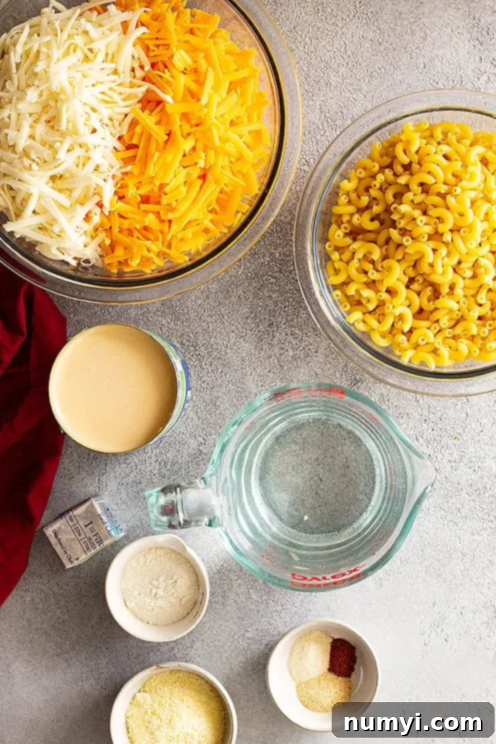Overhead shot showcasing all the simple, easy-to-find ingredients needed to make the best evaporated milk mac and cheese, arranged neatly on a surface.