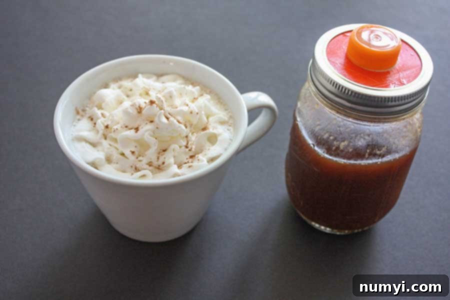 A comforting homemade pumpkin spice latte, topped with a generous swirl of whipped cream, in a classic white coffee mug.
