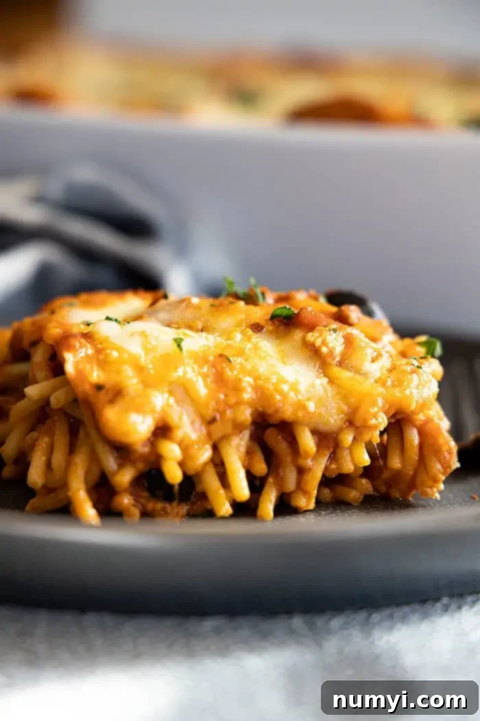 Million Dollar Baked Spaghetti 2 side view: my million dollar spaghetti recipe on a plate with layers showing