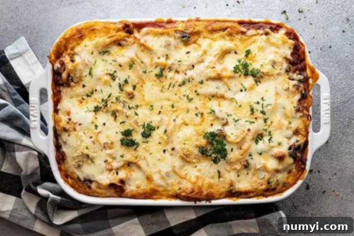Million Dollar Baked Spaghetti 6 overhead: easy million dollar spaghetti garnished with fresh parsley and a little red pepper flake after baking