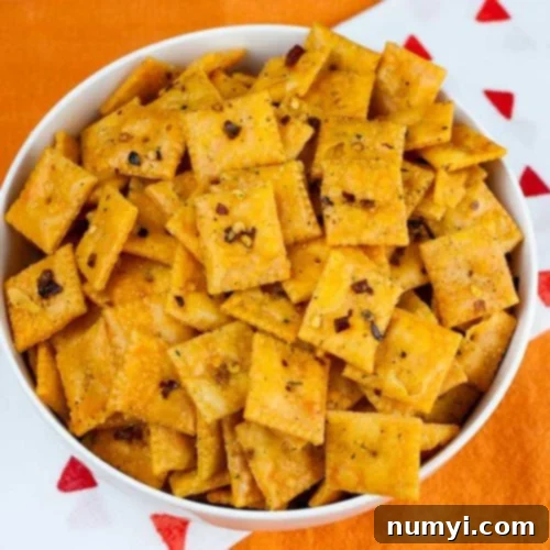 Exploding Cheese Bites 8 Firecracker Cheez-Itz in a white bowl on an orange table cloth.