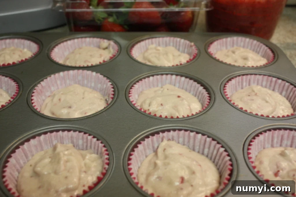 Cupcake batter divided among cupcake liners.
