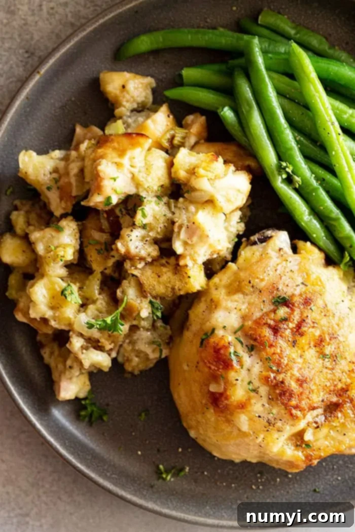 Comforting Chicken and Stuffing Bake 7 overhead: a serving of chicken and stuffing casserole on a plate with fresh green beans on the side