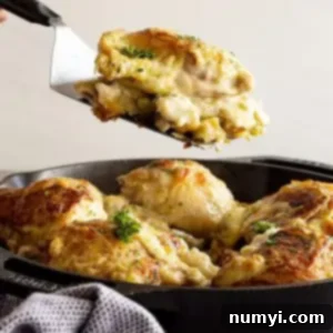 Comforting Chicken and Stuffing Bake 8 Lifting a portion of the casserole out of the pan ready to serve onto a plate.