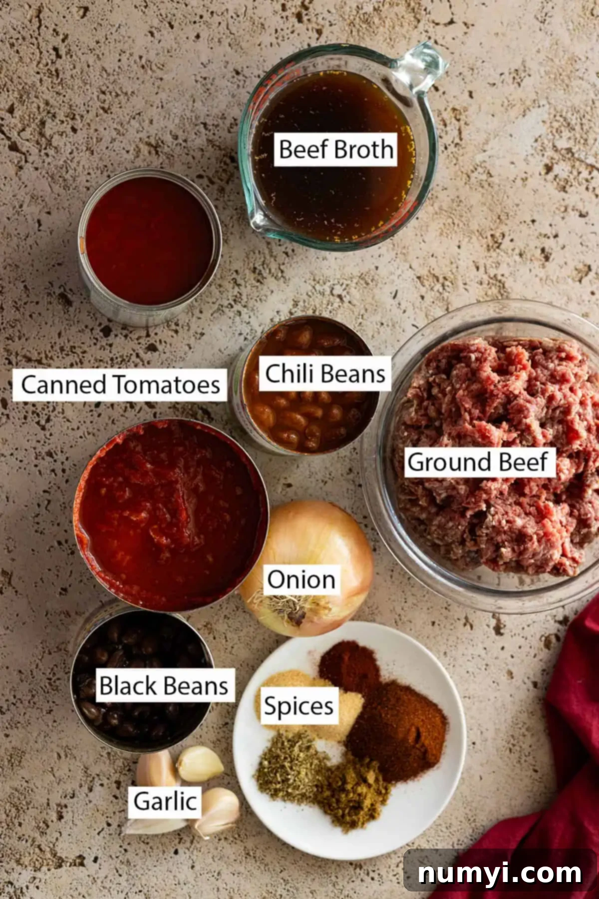 Ingredients: ground beef, beef broth, canned tomatoes, chili beans, black beans, onion, spices, garlic.