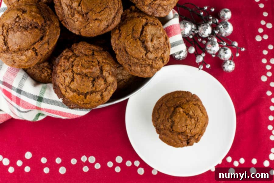 Spiced Molasses Muffins 2 Basket of warm, spiced gingerbread muffins with a festive red, white, and green towel, perfect for holiday mornings.