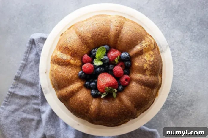 The Quintessential Pound Cake 6 Overhead view of a beautiful bundt pound cake with fresh berries piled high in the center, ready to be served.