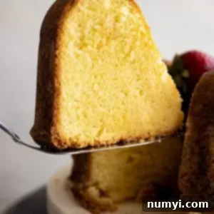 The Quintessential Pound Cake 8 A slice of cake being cut from the cake.
