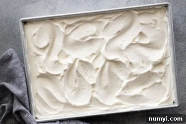 Whipped cream spread over the cake.