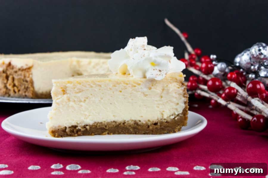 A perfectly baked and chilled slice of eggnog cheesecake on a white plate, showcasing its smooth texture.