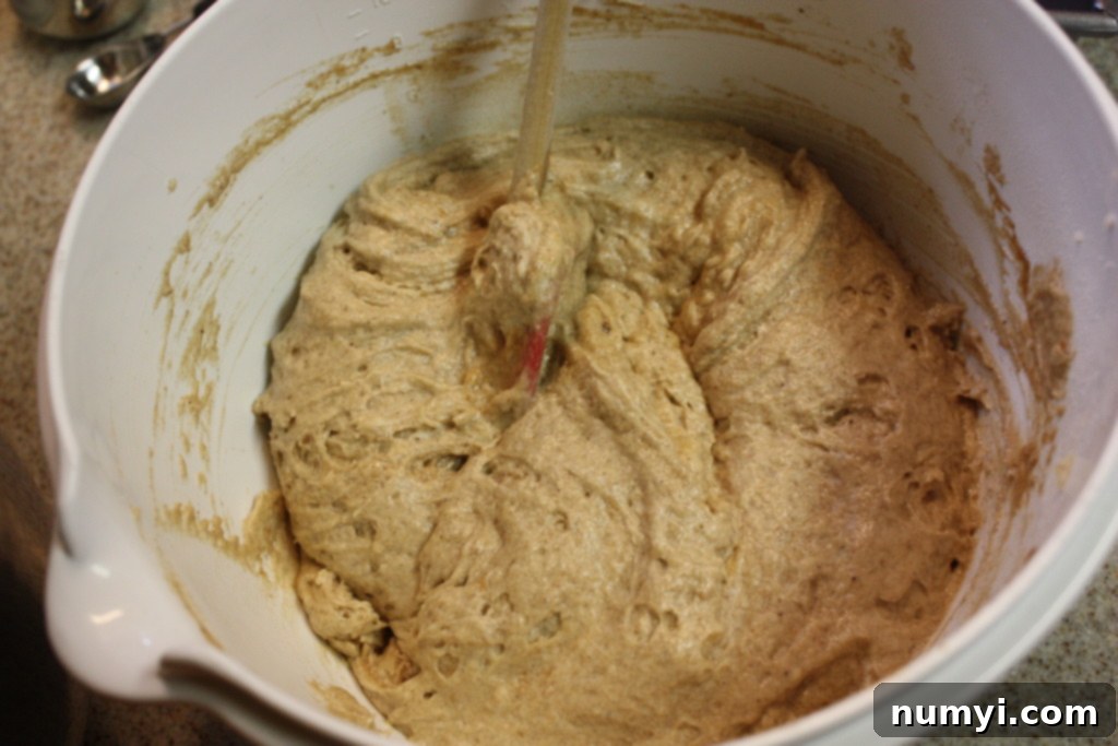 Apple butter bread batter being mixed in a white bowl, smooth and ready for the pan.