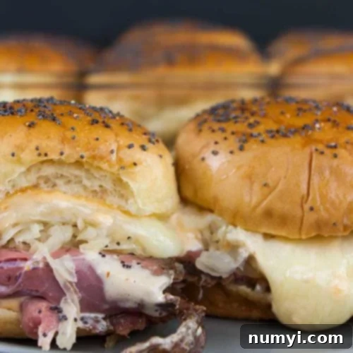 Pastrami and swiss cheese sliders close up.