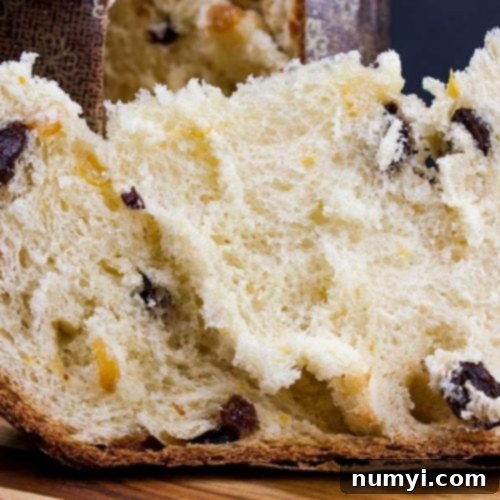 Simple Italian Christmas Panettone 19 Panettone on a wooden cutting board.