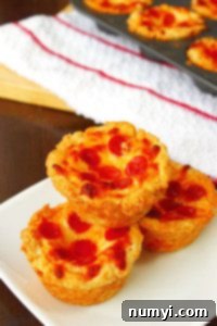 Close-up of baked mini deep dish pizzas with golden crust and bubbly pepperoni