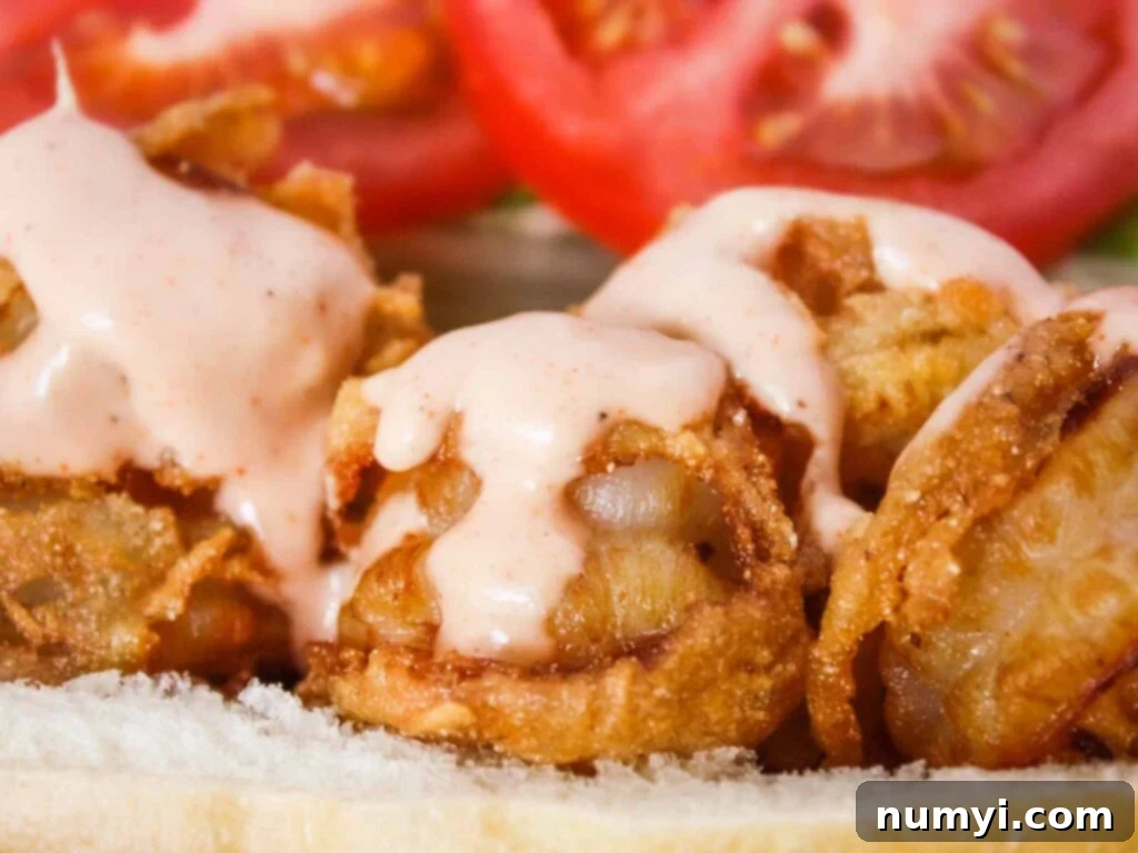 Two shrimp po'boys in a brown paper lined red basket, ready to serve.