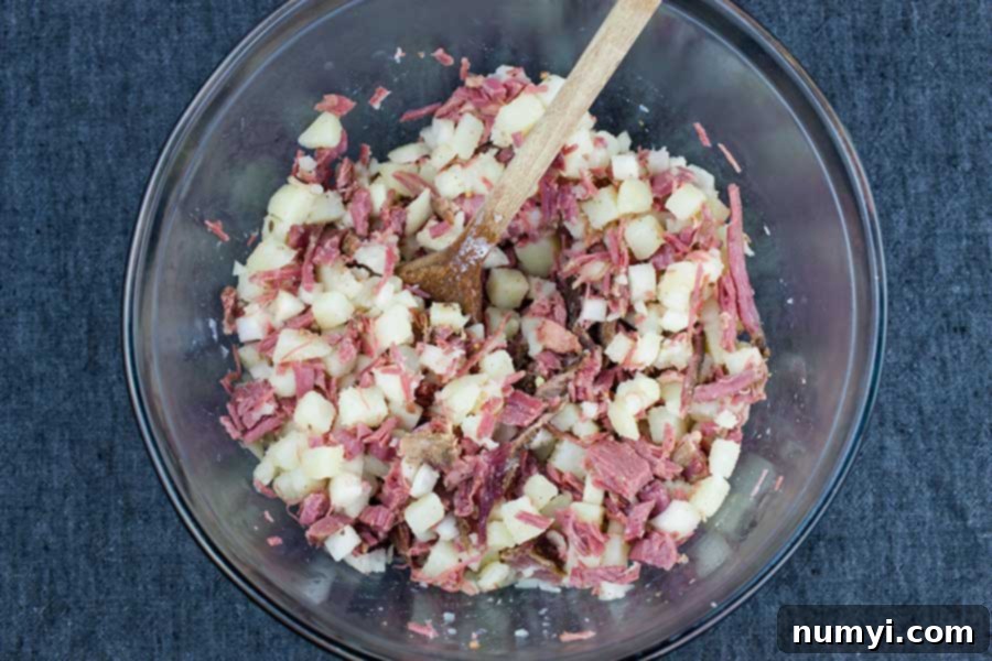 Diced onions gently sautéing in melted butter in a hot skillet, becoming translucent and fragrant.