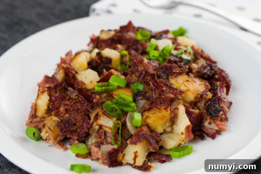 A large skillet filled with perfectly cooked, crispy corned beef hash, ready to be served.