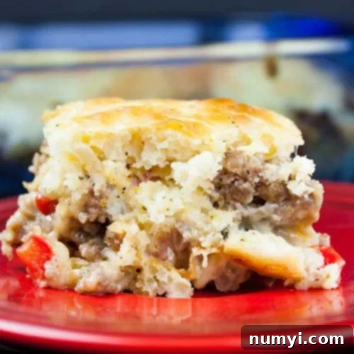 Hearty Sausage Breakfast Casserole 8 A delicious slice of sausage breakfast cake on a red plate, highlighted for the recipe card.