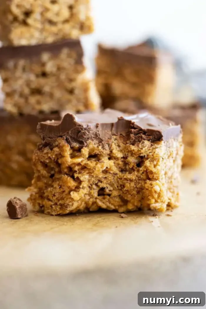 Close up of this scotcheroo recipe. Layers of cereal and chocolate are visible.