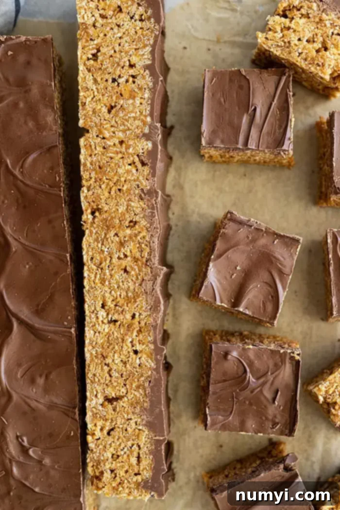 Overhead view of scotcharoo bars being cut into bars. 