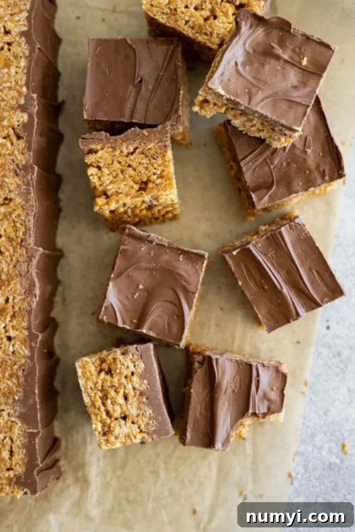 Several scotcheroo recipe bars scattered with some on their sides and some stacked on top of each other