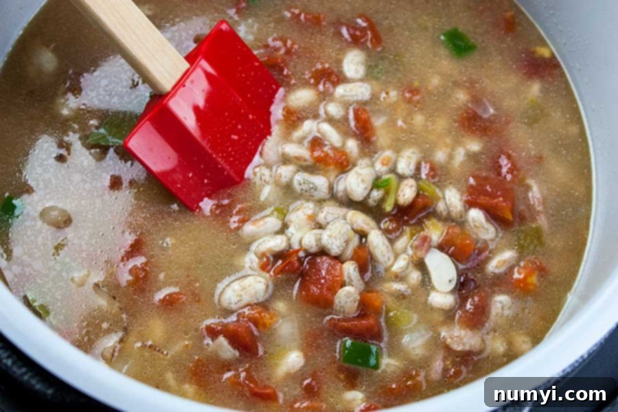 Diced bacon, onions, and jalapenos sautéing in the Ninja Foodi pot, creating a fragrant base for Mexican pinto beans.