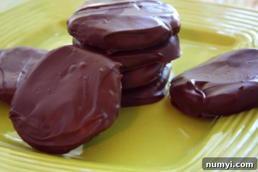 Thin Mint Cookies stacked on a green plate.