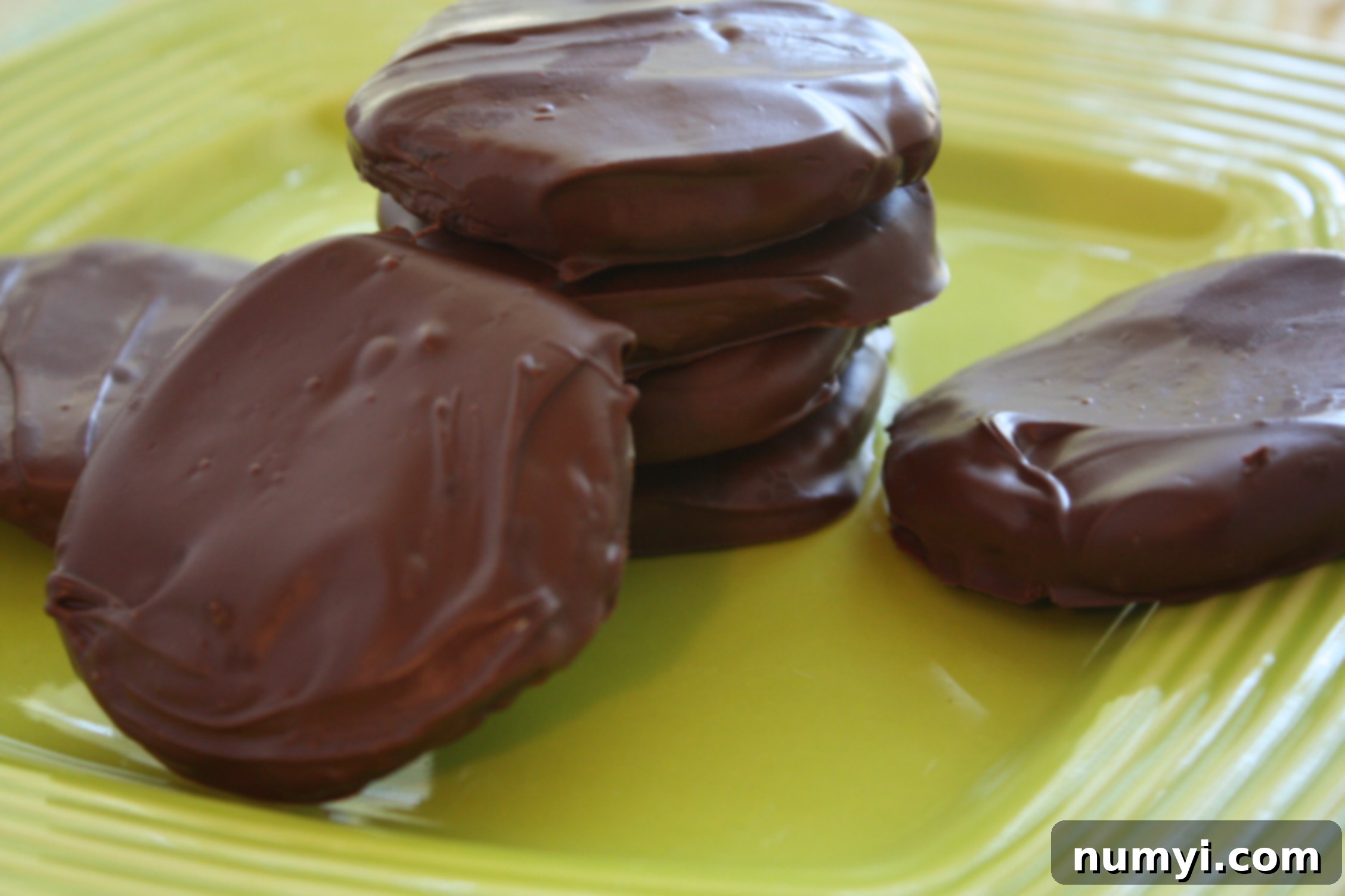 Stacked homemade Thin Mint cookies on a plate.