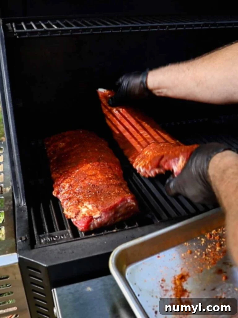 The Ultimate Smoked Baby Back Ribs 8 Placing baby back ribs onto the smoker.