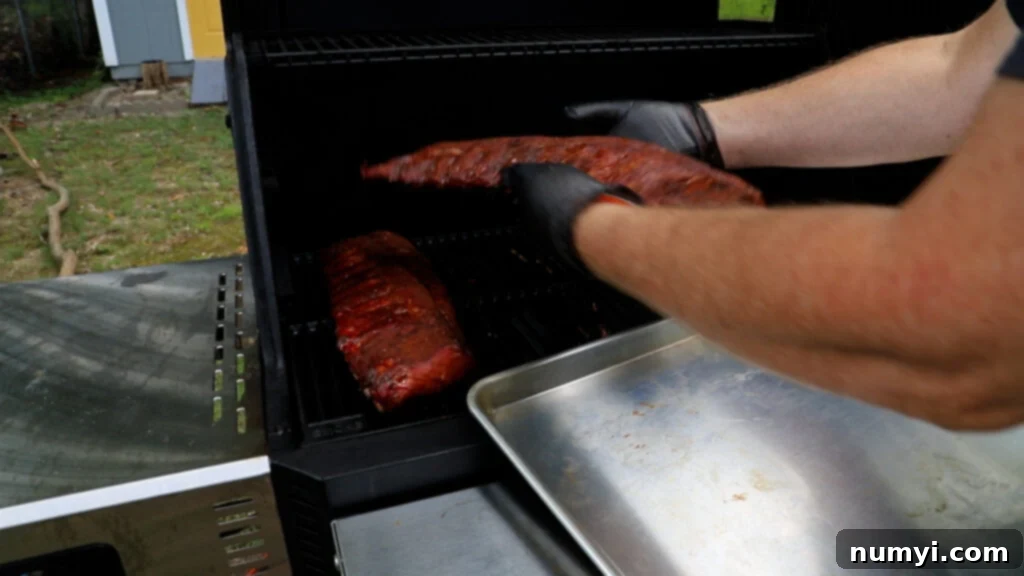 The Ultimate Smoked Baby Back Ribs 10 Removing the ribs from the Masterbuilt smoker after three hours of smoking.